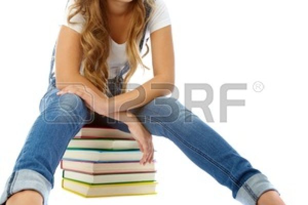 12057178-pretty-teenager-heap-books-looking-camera-isolation-1