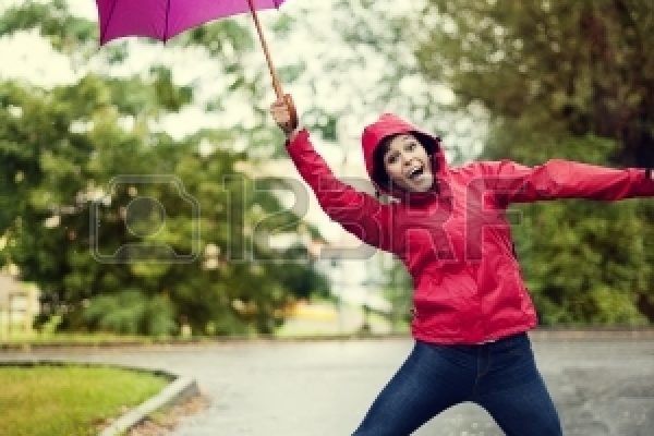 18185163-cheerful-woman-jumping-umbrella
